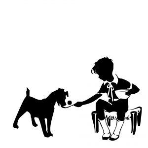 Silhouette of a boy feeding a dog
